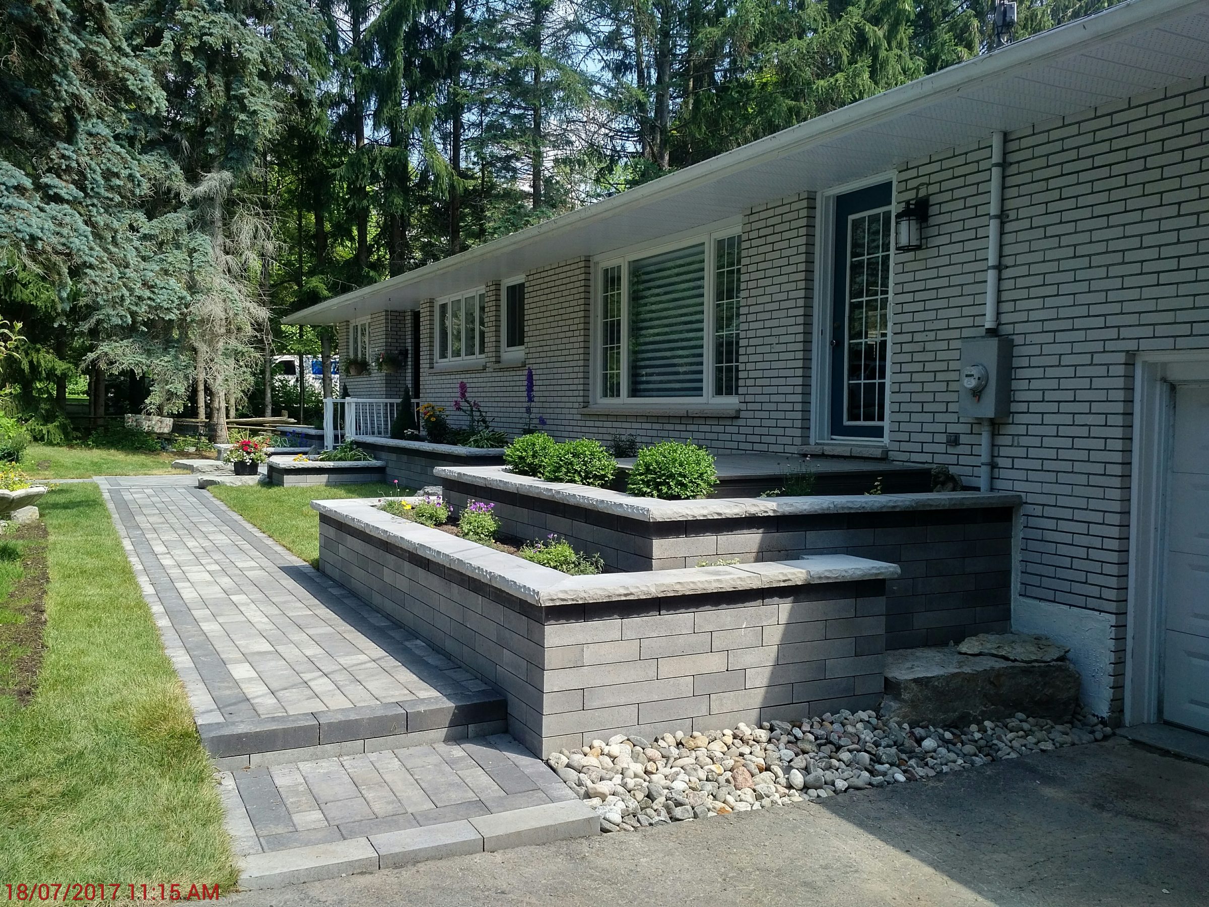 Brick path leading to a modern house entrance
