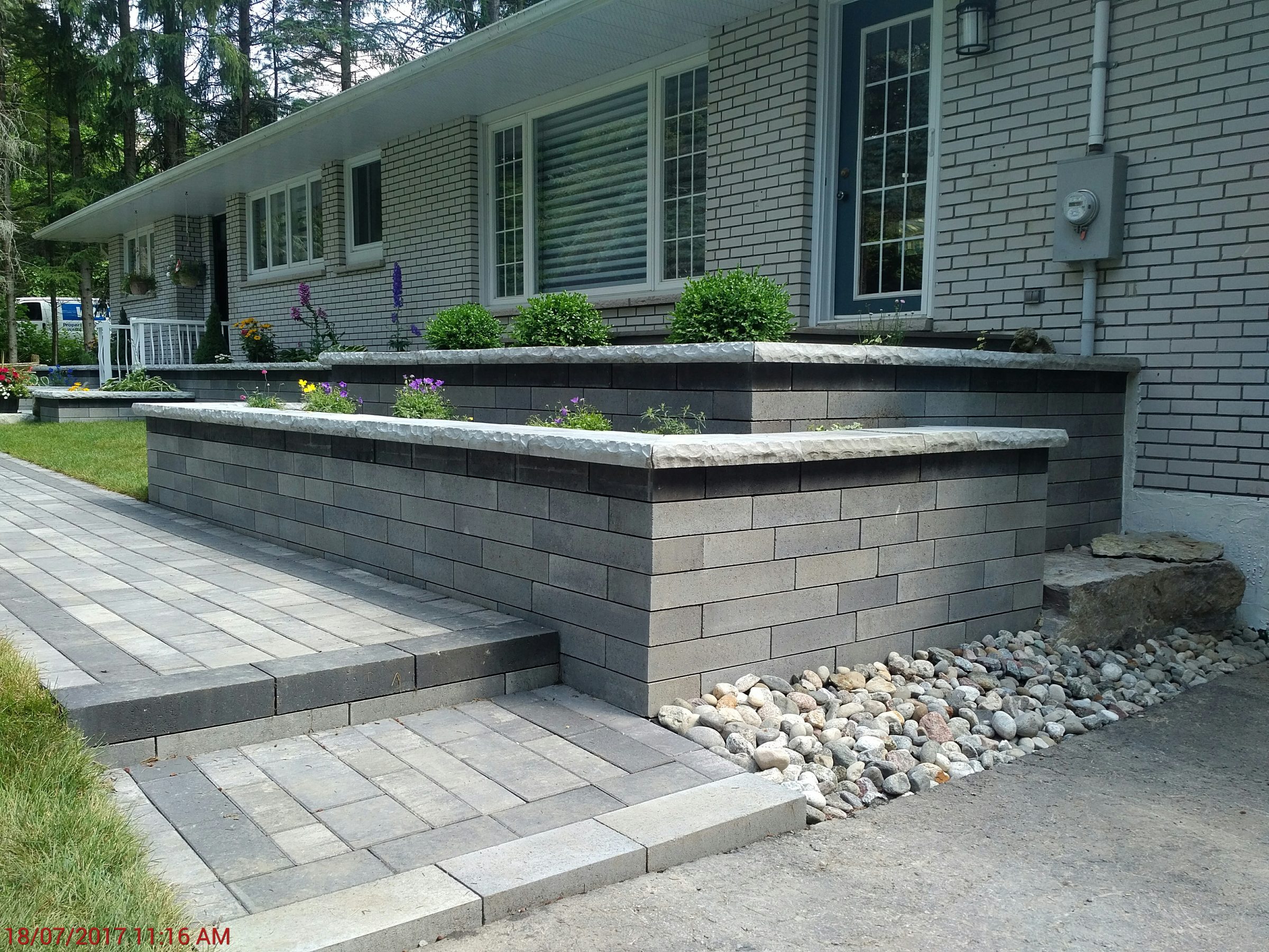 Brick retaining wall with landscaped garden
