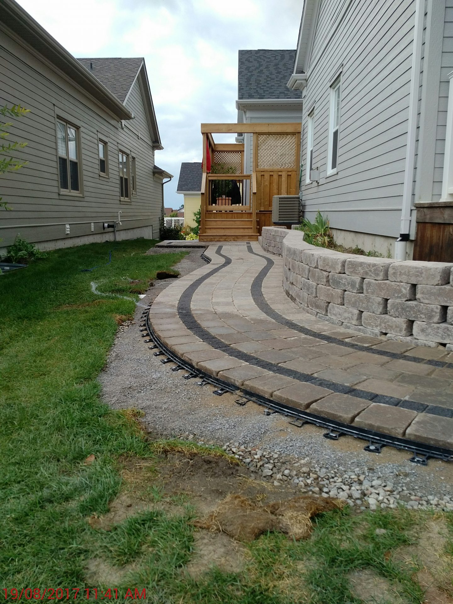 Curved paver pathway between houses
