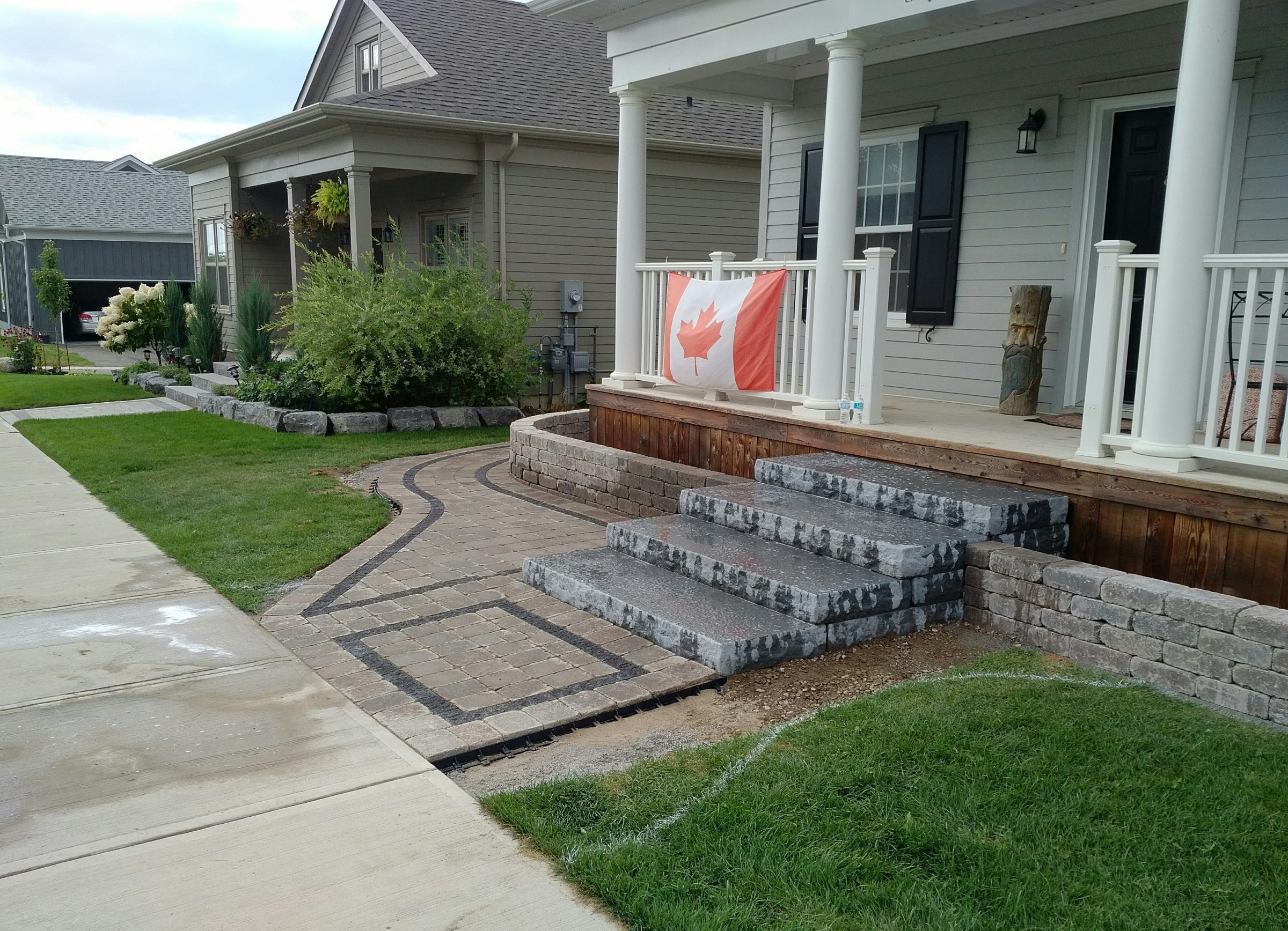 House porch with Canadian flag and garden