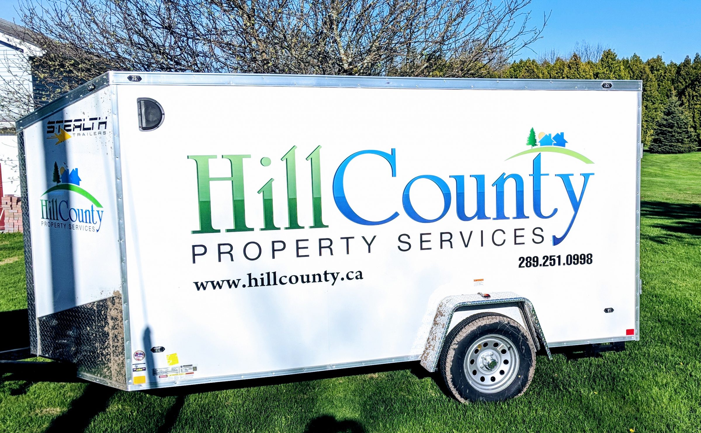 Hill County Property Services trailer on grass