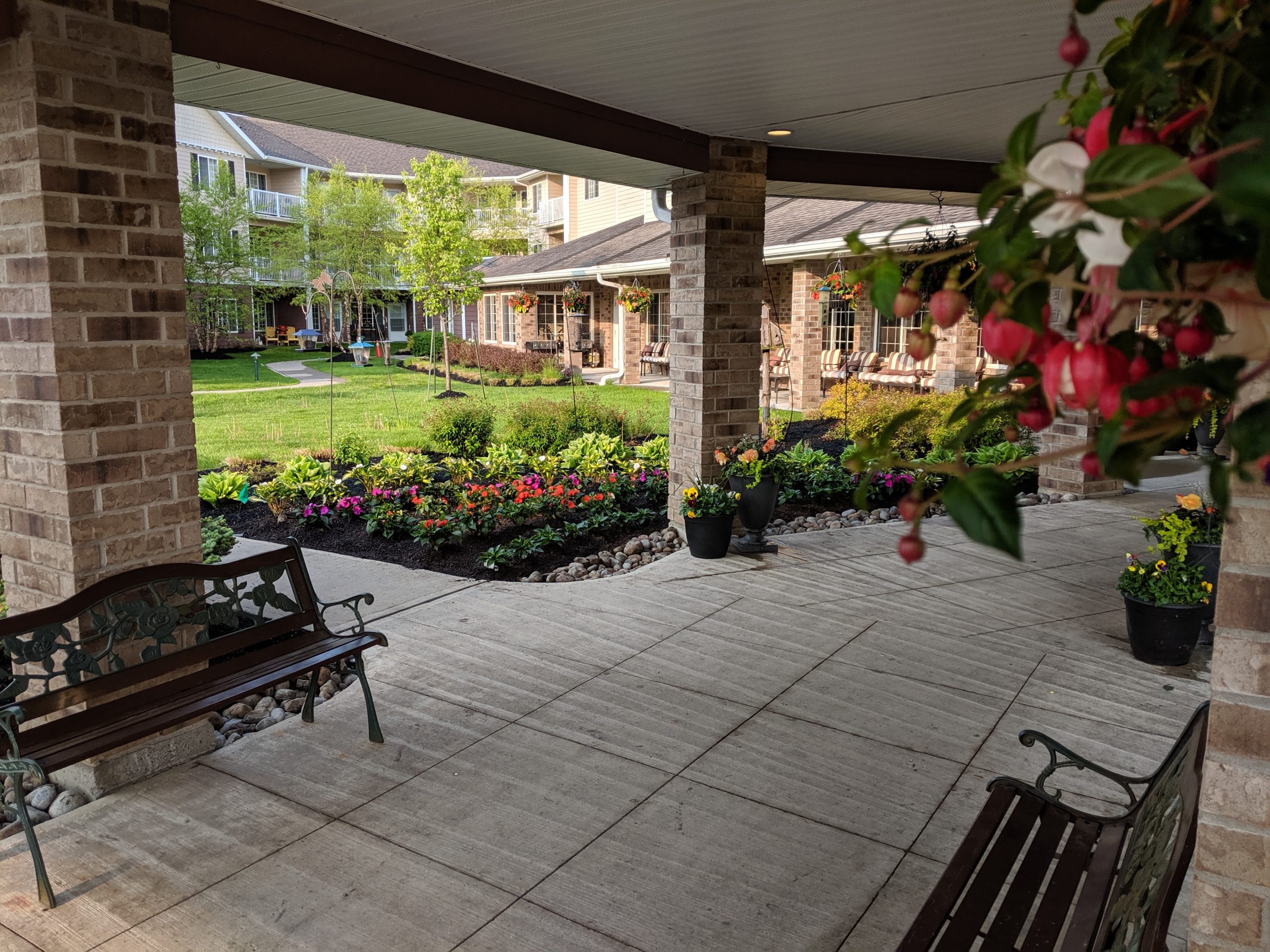 Courtyard with benches and colorful garden flowers.