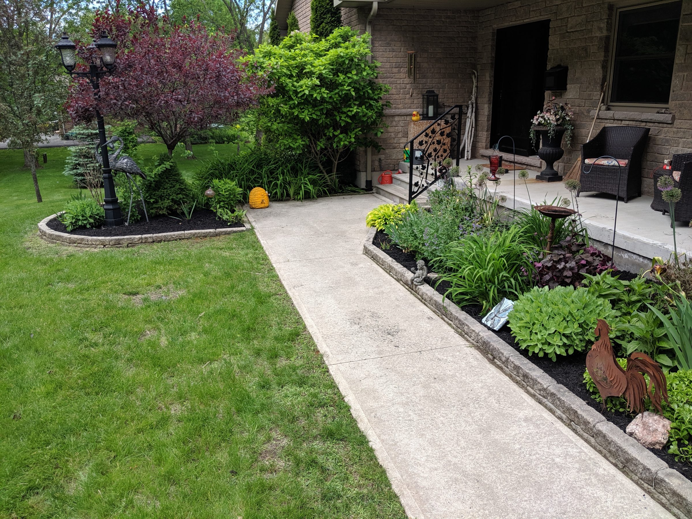 Lush garden path with plants and outdoor decor.