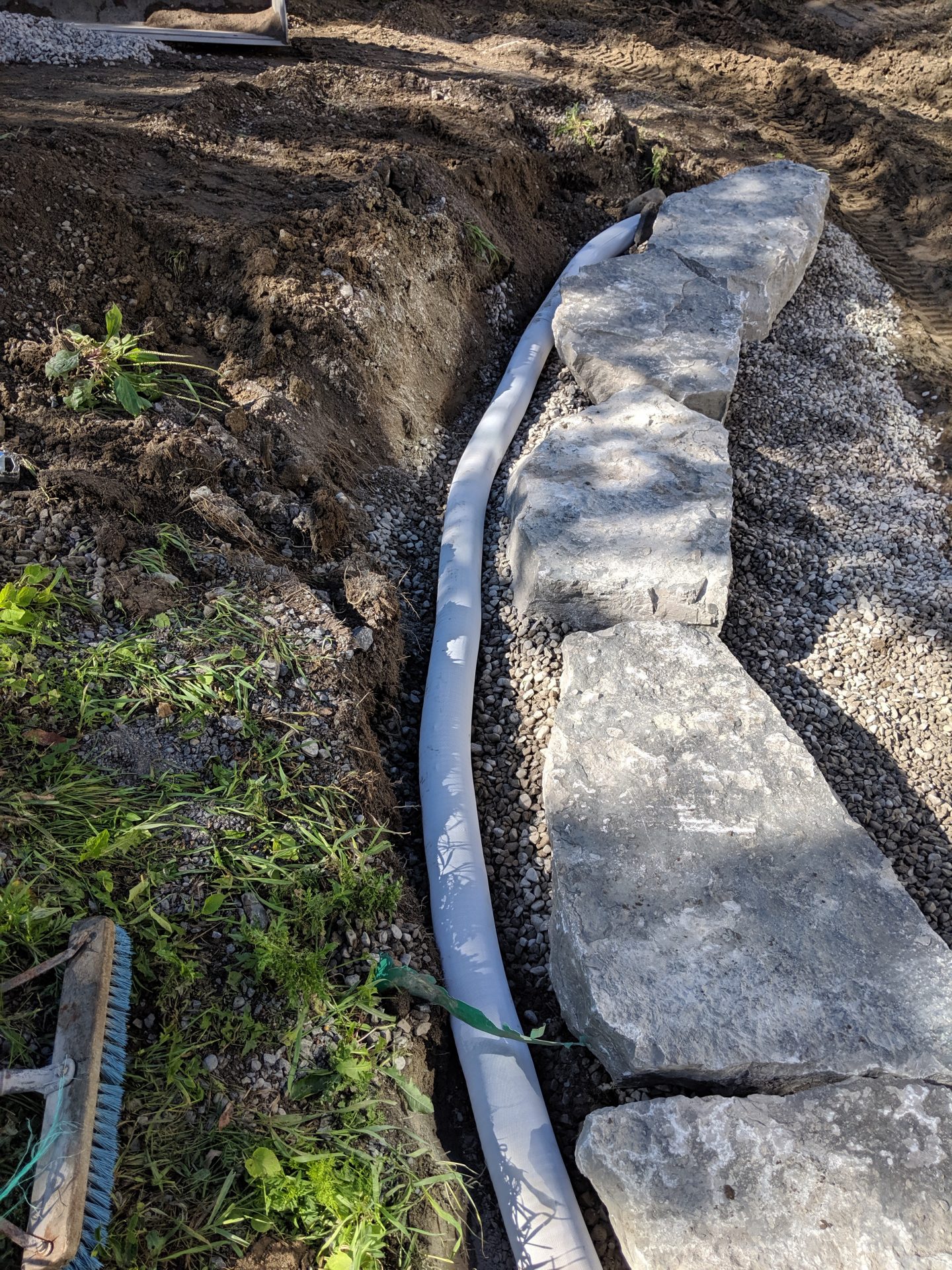 Stone path with drainage pipe installation