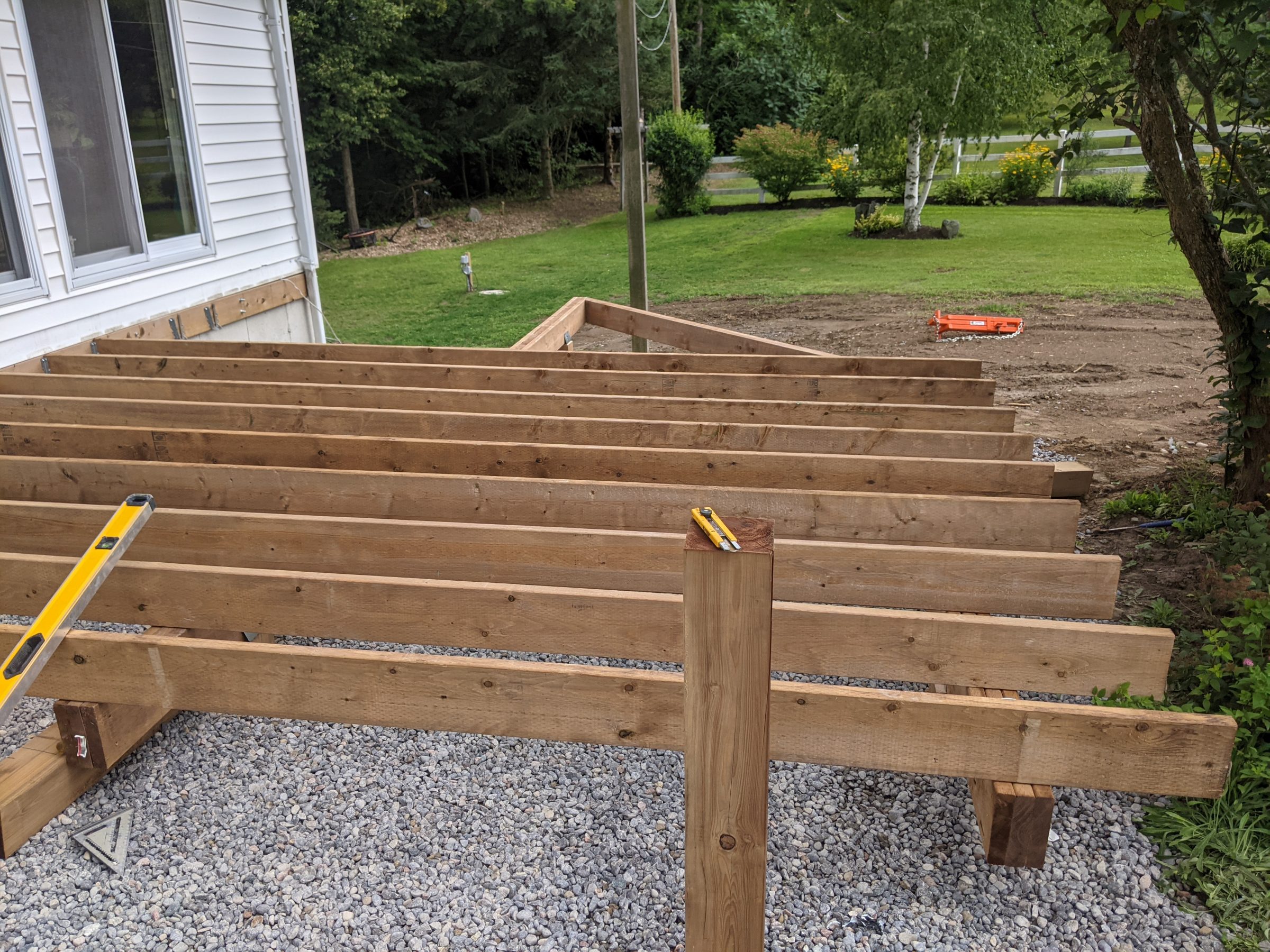 Wooden deck frame under construction in backyard