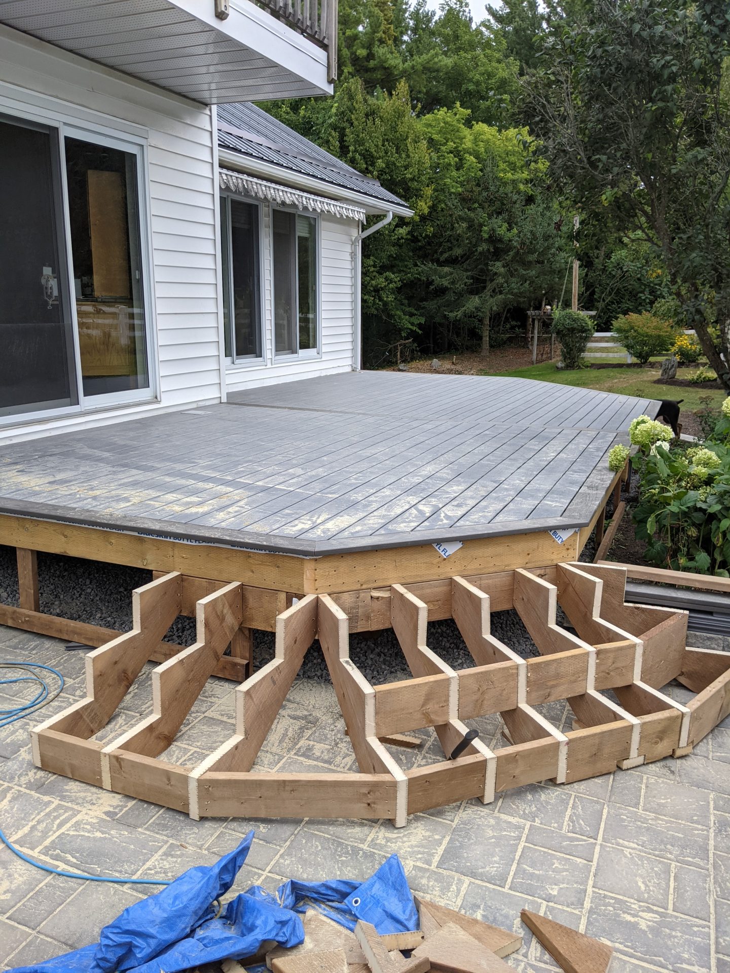 Unfinished wooden deck stairs construction in progress.