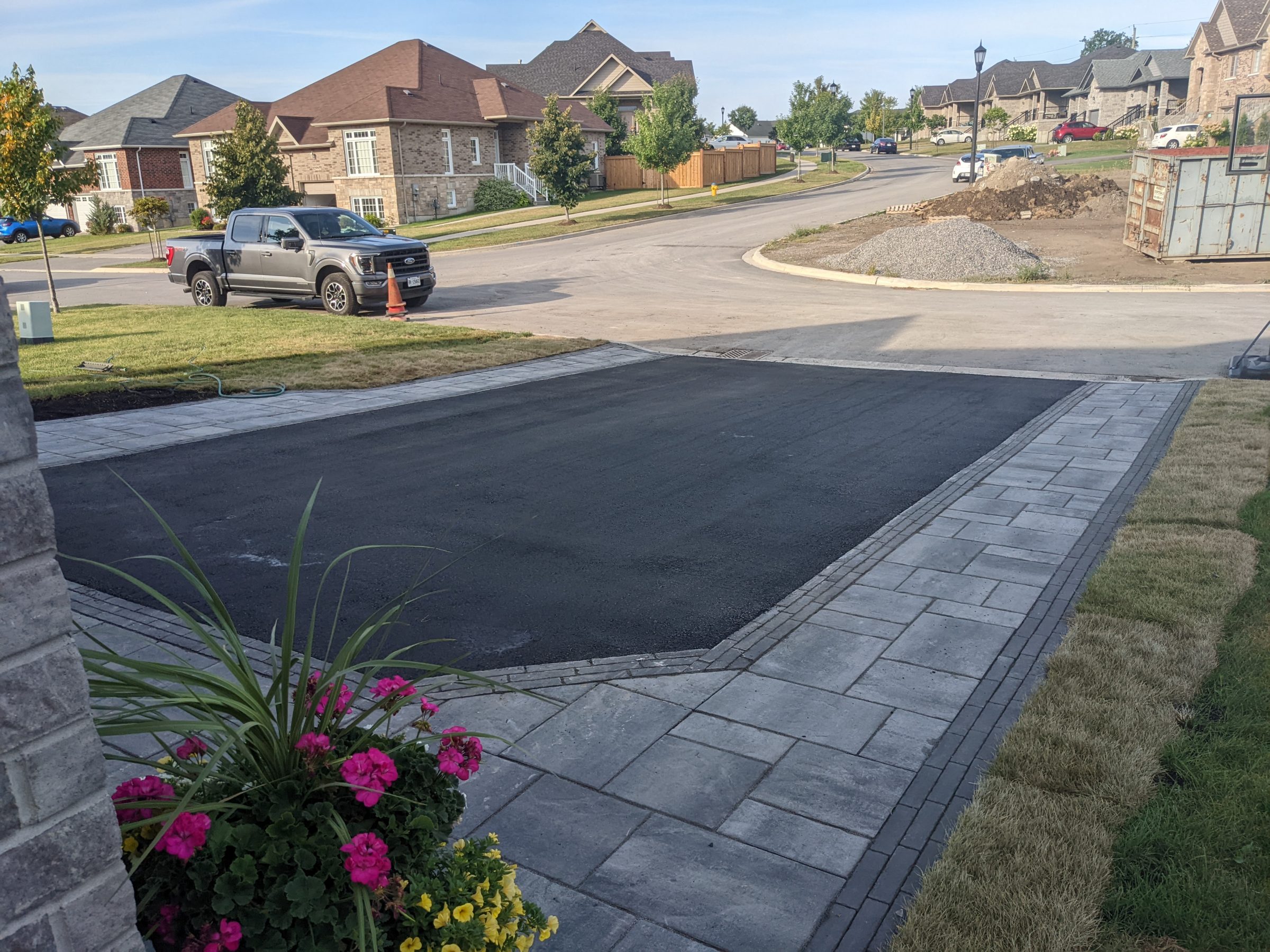 Residential neighborhood with freshly paved driveway.