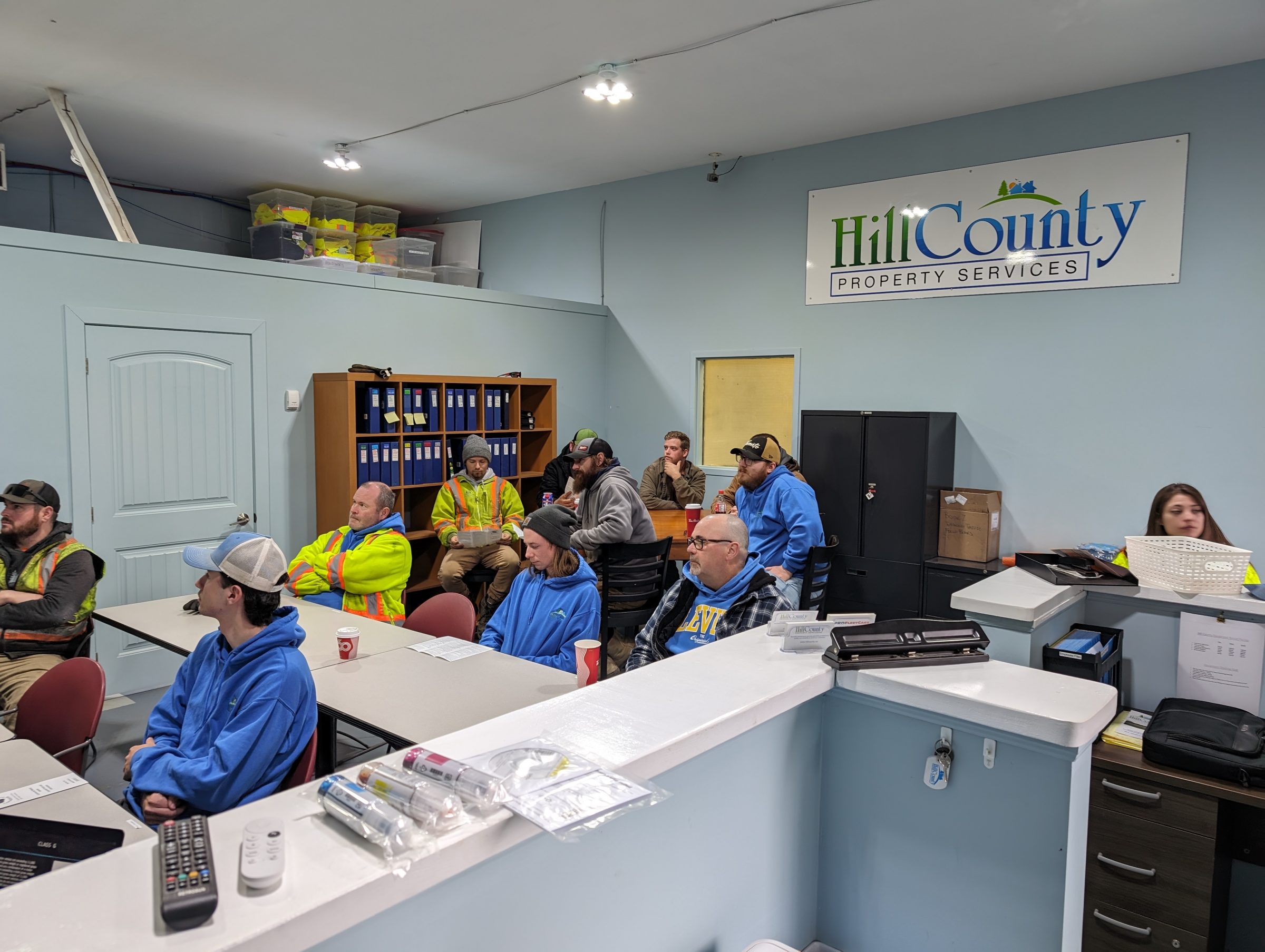 Employees attending a meeting at Hill County office.