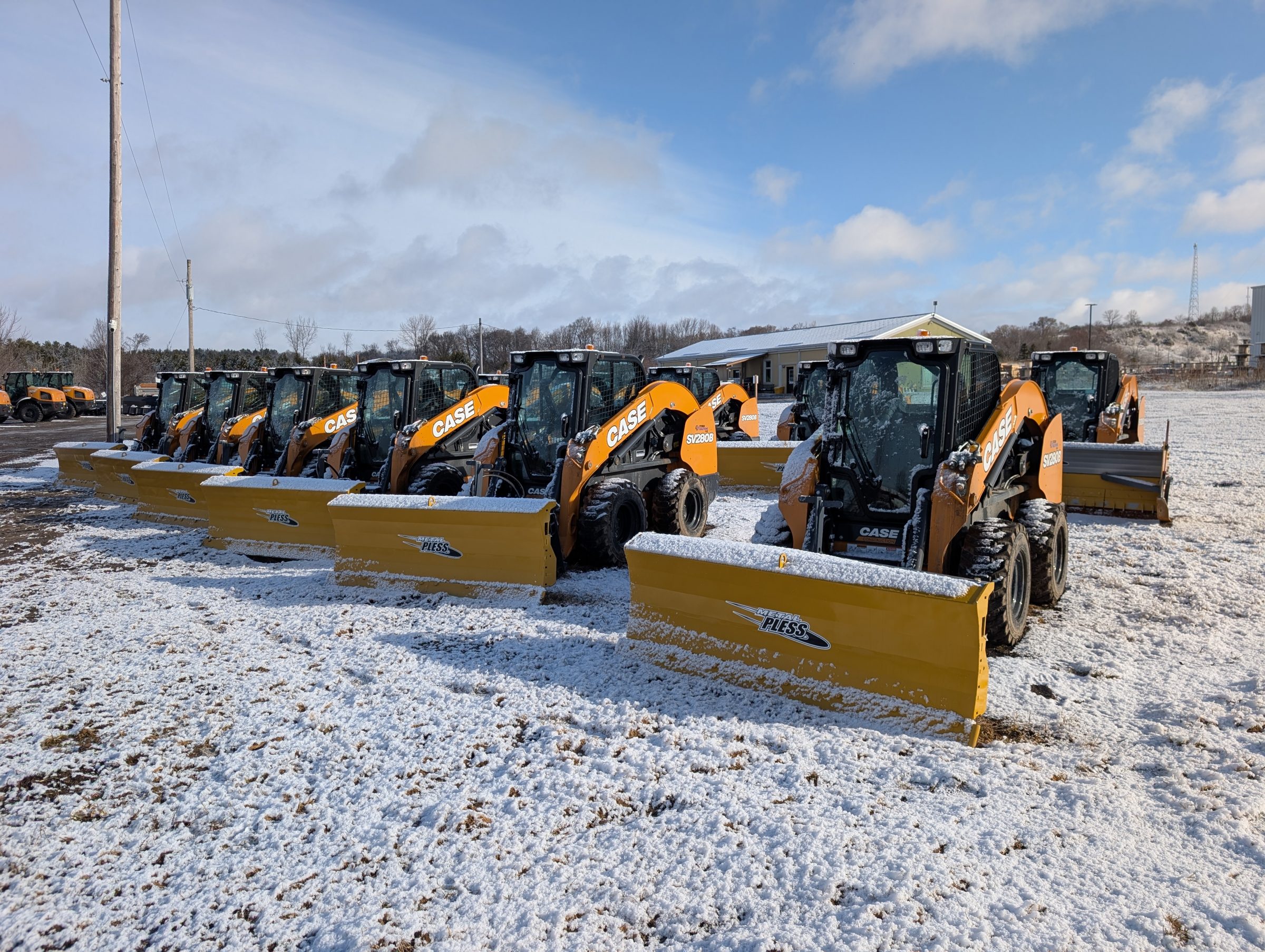 Row of snow plows on snowy ground