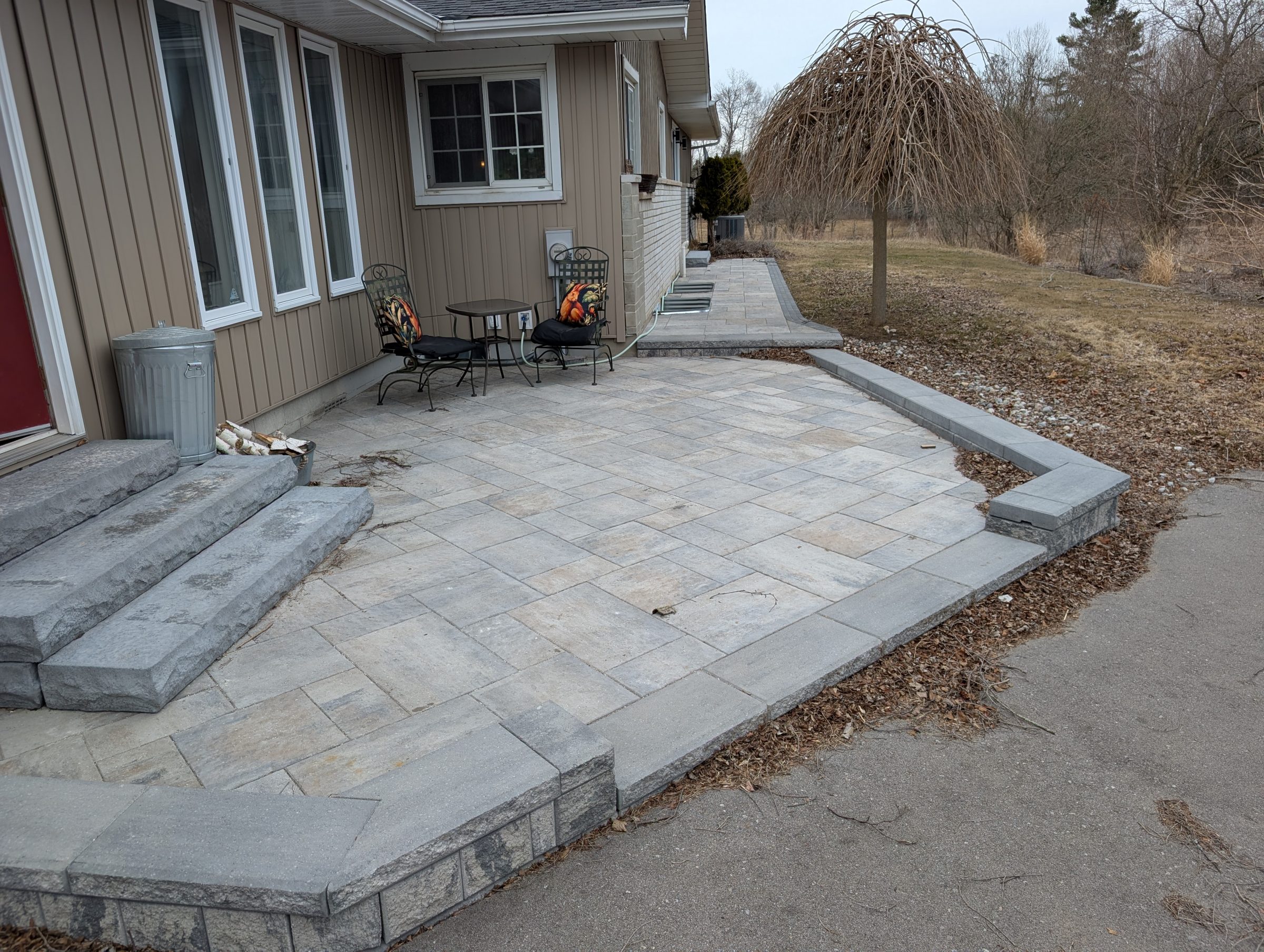 Stone patio with chairs and table.
