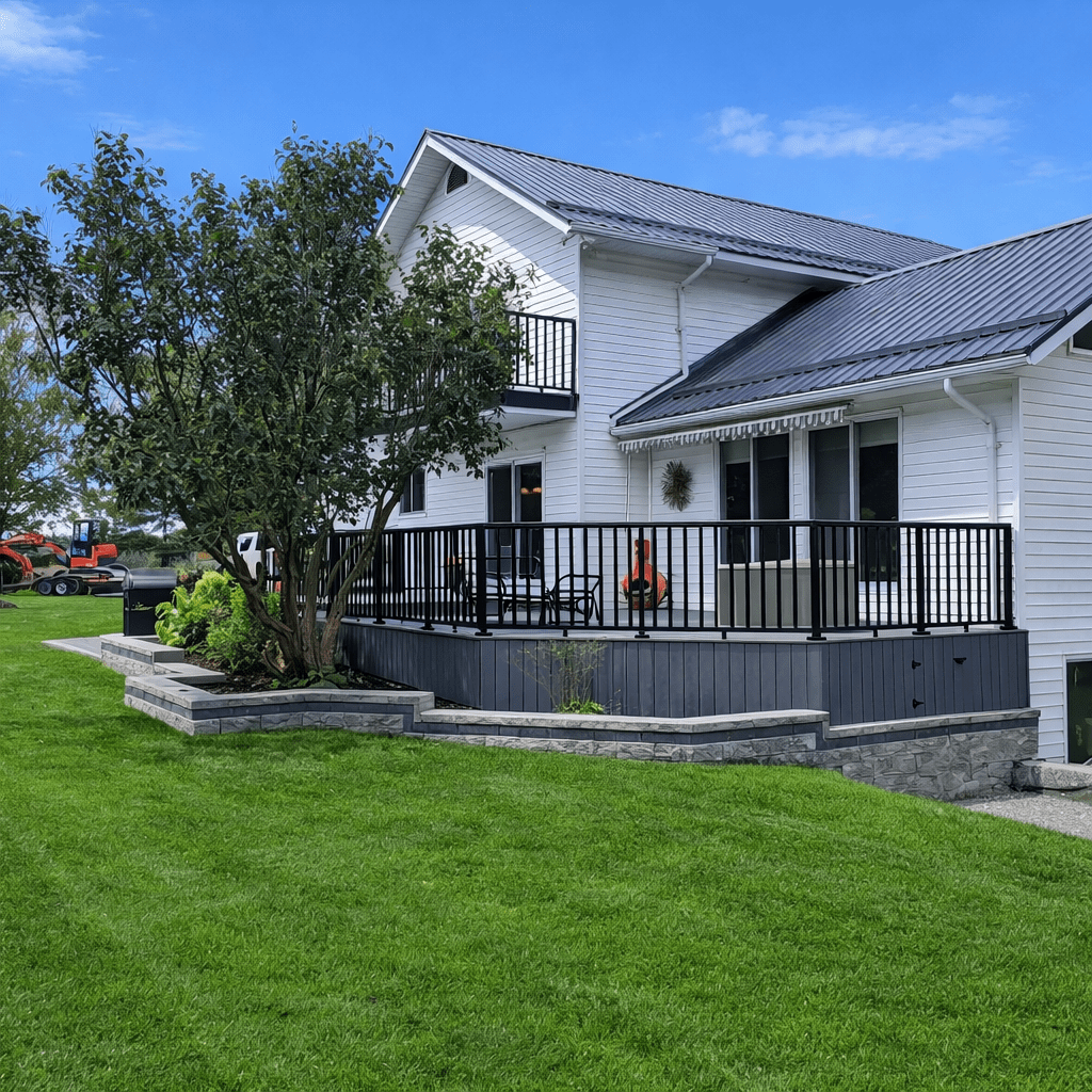 Modern white house with large deck and lawn.