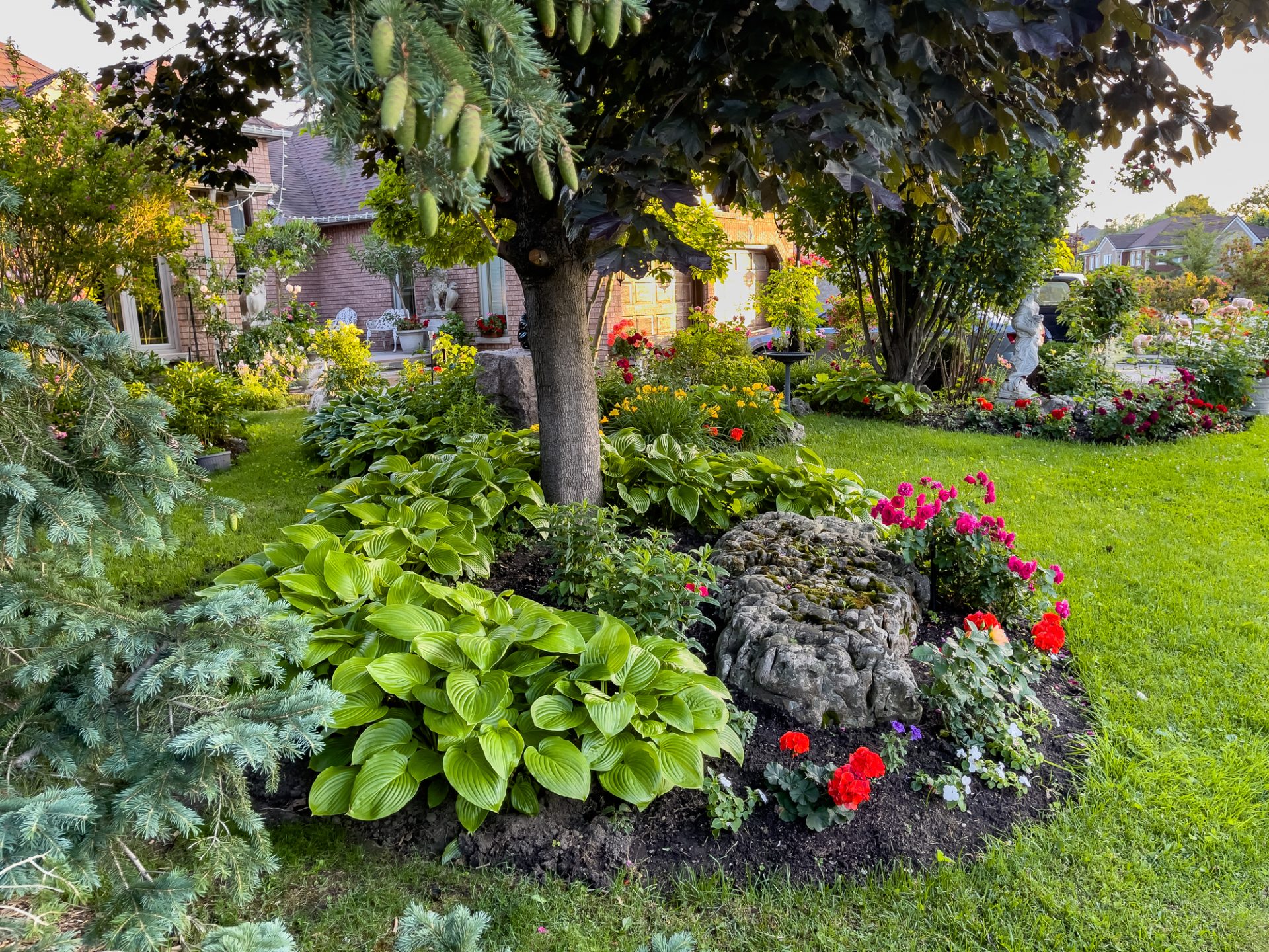 Lush garden with colorful flowers and trees.