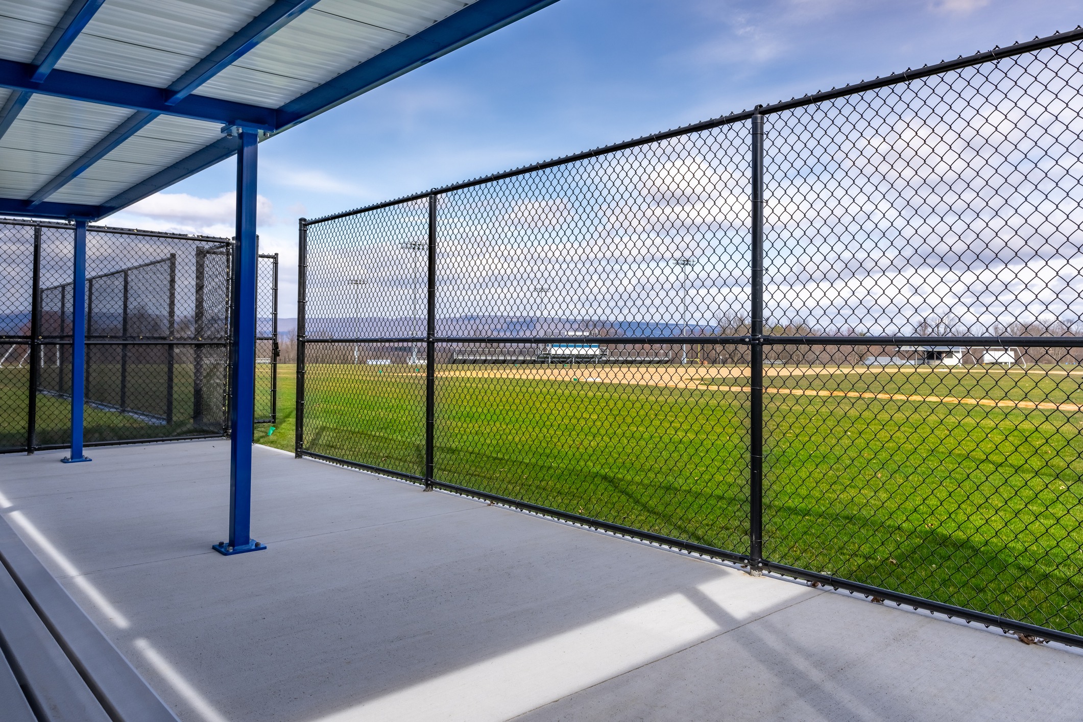 View of baseball field through chain-link fence.