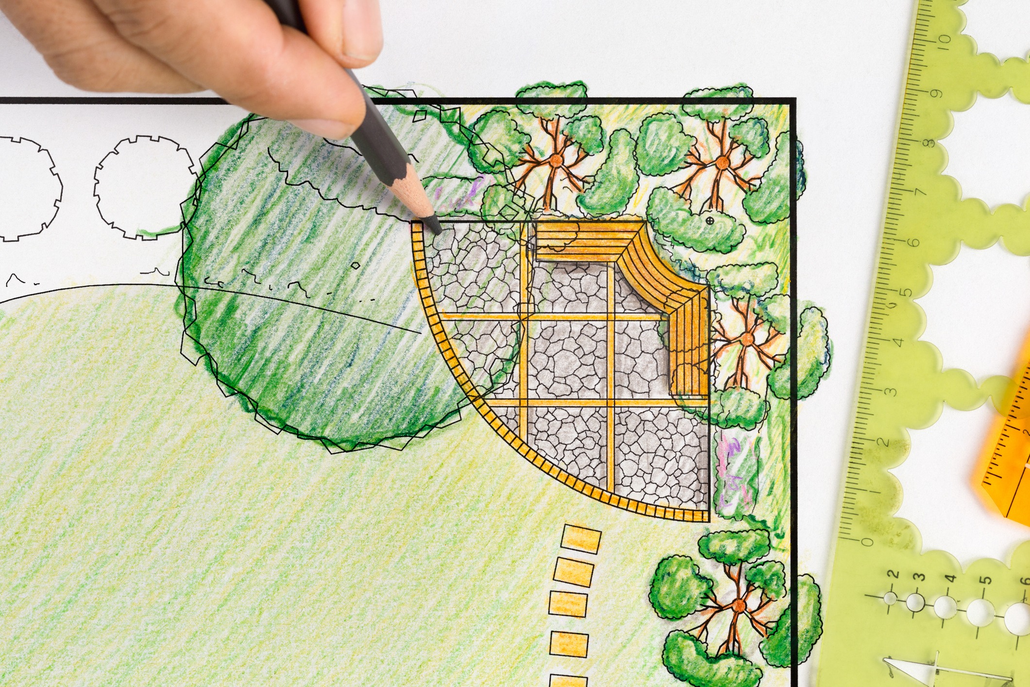 Hand drawing landscape garden design plan with tools.