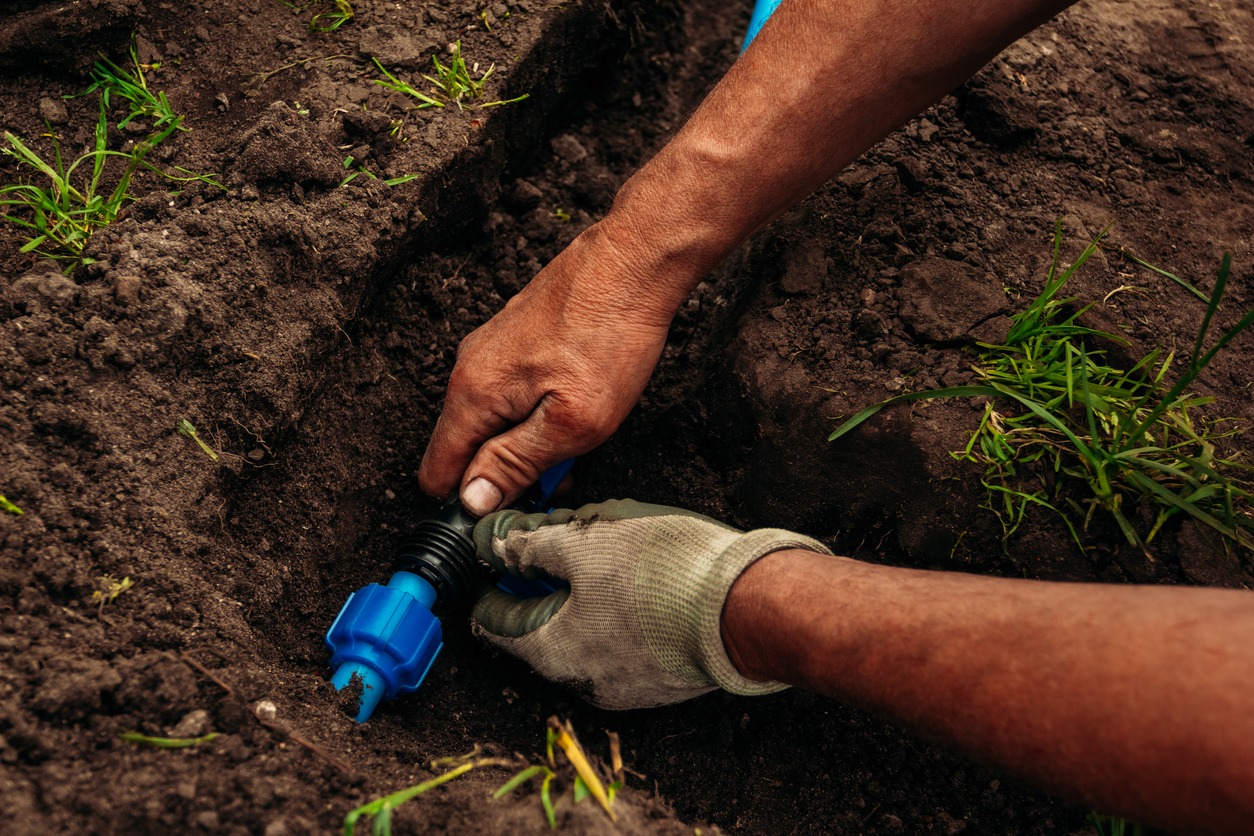 Installing garden irrigation system in soil
