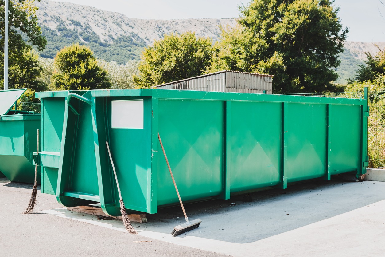 Large green dumpster in outdoor setting